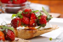 Bruschetta with strawberries, basil and cream cheese.