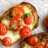 Bruschetta with grilled cherry tomatoes and Greek traditional cheese metsovone