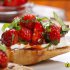 Bruschetta with strawberries, basil and cream cheese.