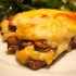 Finely Sliced Veal with Mushrooms and Cheese in the Oven