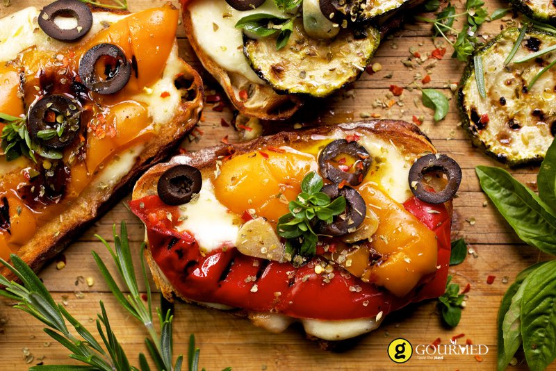 Bruschetta with Greek graviera cheese from Crete and grilled vegetables